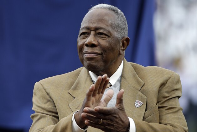 Hank Aaron applauds during a ceremony celebrating the 40th anniversary of his 715th home run before the start of a baseball game between the Atlanta Braves and the New York Mets, Tuesday, April 8, 2014, in Atlanta. (AP Photo/David Goldman)