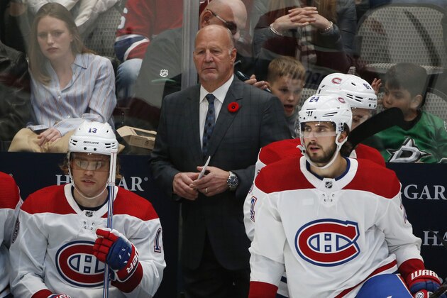 Montreal Canadiens coach Claude Julien watches his team play the Dallas Stars, from behind center Max Domi (13) and left wing Phillip Danault (24), during the second period of an NHL hockey game in Dallas, Saturday, Nov. 2, 2019. (AP Photo/Michael Ainsworth)