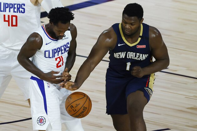 Los Angeles Clippers' Patrick Beverley, left, loses the ball as New Orleans Pelicans' Zion Williamson defends during the first half of an NBA basketball game Saturday, Aug. 1, 2020, in Lake Buena Vista, Fla. (Kevin C. Cox/Pool Photo via AP)