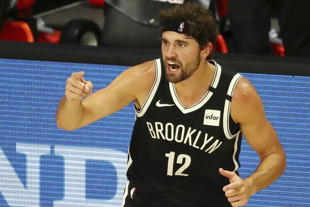 Brooklyn Nets forward Joe Harris (12) celebrates after making a three-point basket against the Washington Wizards in the first half of an NBA basketball game Sunday, Aug. 2, 2020, in Lake Buena Vista, Fla. (Kim Klement/Pool Photo via AP)