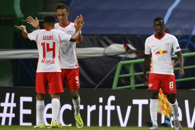Leipzig's Tyler Adams, left, celebrates with teammates after scoring his team's second goal during the Champions League quarterfinal match between RB Leipzig and Atletico Madrid at the Jose Alvalade stadium in Lisbon, Portugal, Thursday, Aug. 13, 2020. (Lluis Gene/Pool Photo via AP)