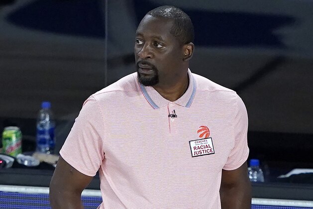 Toronto Raptors assistant coach Adrian Griffin looks on during the first half of an NBA basketball game while leading the team after head coach Nick Nurse stepped down for a the night to let Griffin coach against the Philadelphia 76ers Wednesday, Aug. 12, 2020 in Lake Buena Vista, Fla. (AP Photo/Ashley Landis, Pool)