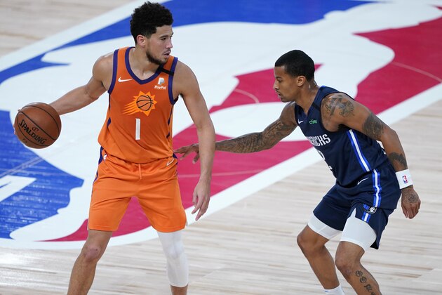 Phoenix Suns' Devin Booker (1) dribbles as Dallas Mavericks' Trey Burke defends during the second half of an NBA basketball game Thursday, Aug. 13, 2020 in Lake Buena Vista, Fla. (AP Photo/Ashley Landis, Pool)