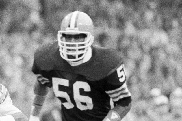 San Diego Chargers receiver Charlie Joiner (18) is dragged down by Cleveland Browns defender Clarence Scott after a catch in the first quarter of the game in Cleveland Stadium, Dec. 5, 1982. Coming up from behind is Browns' linebacker Chip Banks (56).  (AP Photo/Bruce Zake)