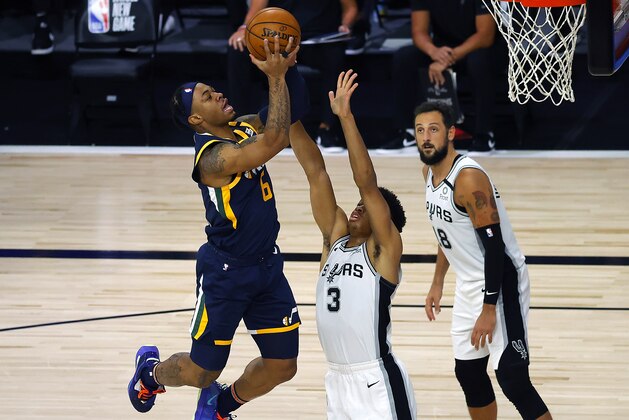 Utah Jazz's Rayjon Tucker (6) scores against San Antonio Spurs' Keldon Johnson (3) during the third quarter of an NBA basketball game Thursday, Aug. 13, 2020, in Lake Buena Vista, Fla. (Kevin C. Cox/Pool Photo via AP)