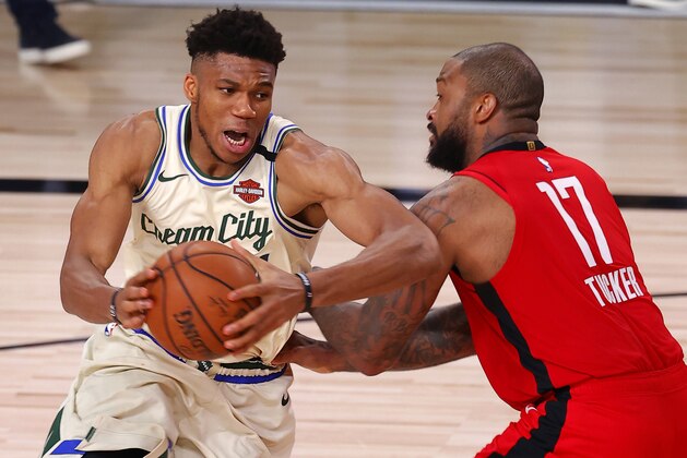 Milwaukee Bucks' Giannis Antetokounmpo drives on Houston Rockets' P.J. Tucker during an NBA basketball game Sunday, Aug. 2, 2020, in Lake Buena Vista, Fla. (Mike Ehrmann/Pool Photo via AP)