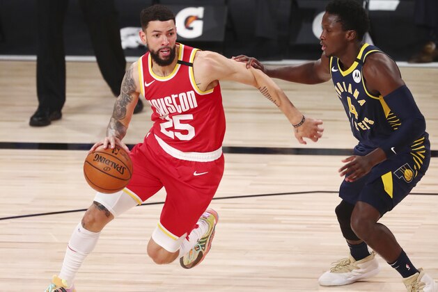 Houston Rockets guard Austin Rivers (25) dribbles the ball against Indiana Pacers guard Victor Oladipo (4) in the first half of an NBA basketball game Wednesday, Aug. 12, 2020, in Lake Buena Vista, Fla. (Kim Klement/Pool Photo via AP)