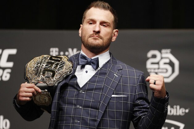 FILE - In this July 5, 2018, file photo, Stipe Miocic poses during a news conference for UFC 226 in Las Vegas. Heavyweight champion Stipe Miocic welcomes the UFC's planned return. The fighter and firefighter does have some worries, though. (AP Photo/John Locher, File)