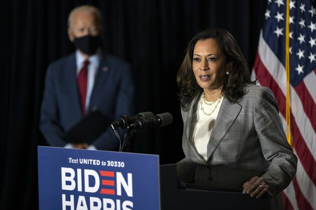 Democratic presidential candidate former Vice President Joe Biden stands left as his running mate Sen. Kamala Harris, D-Calif., speaks at the Hotel DuPont in Wilmington, Del., Thursday, Aug. 13, 2020. (AP Photo/Carolyn Kaster)
