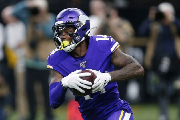 Minnesota Vikings wide receiver Stefon Diggs (14) carries in the second half of an NFL wild-card playoff football game against the New Orleans Saints, Sunday, Jan. 5, 2020, in New Orleans. (AP Photo/Butch Dill)