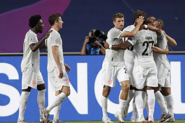 Bayern's Thomas Mueller celebrates with teammates after scoring his sides fourth goal during the Champions League quarterfinal match between FC Barcelona and Bayern Munich at the Luz stadium in Lisbon, Portugal, Friday, Aug. 14, 2020. (AP Photo/Manu Fernandez/Pool)