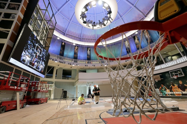 Workers perform restorations at the Naismith Memorial Basketball Hall of Fame, in Springfield, Mass., Tuesday, June 23, 2020. The museum is scheduled to reopen in the beginning of July 2020 with a whole new look after a $22 million renovation.  (AP Photo/Steven Senne)