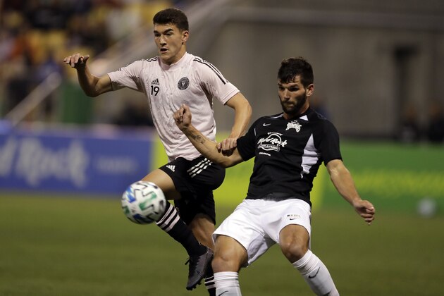 Inter Miami FC's Robbie Robinson (19) and Tampa Bay Rowdies' Forrest Lasso chase the ball during the first half of a preseason friendly soccer match Saturday, Feb. 22, 2020, in St. Petersburg, Fla. (AP Photo/Chris O'Meara)