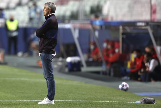 Barcelona's head coach Quique Setien watches from the sideline during the Champions League quarterfinal soccer match between Barcelona and Bayern Munich in Lisbon, Portugal, Friday, Aug. 14, 2020. (Rafael Marchante/Pool via AP)