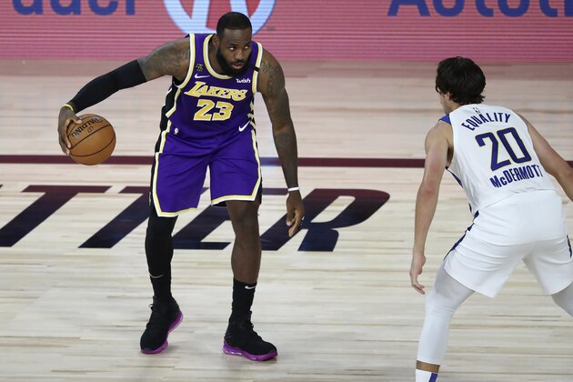 Los Angeles Lakers forward LeBron James (23) handles the ball against Indiana Pacers forward Doug McDermott (20) during the first quarter of an NBA basketball game Saturday, Aug. 8, 2020, in Lake Buena Vista, Fla. (Kim Klement/Pool Photo via AP)