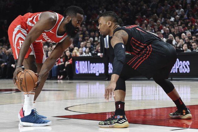 Houston Rockets guard James Harden looks to get past Portland Trail Blazers guard Damian Lillard during the first half of an NBA basketball game in Portland, Ore., Tuesday, March 20, 2018. (AP Photo/Steve Dykes)