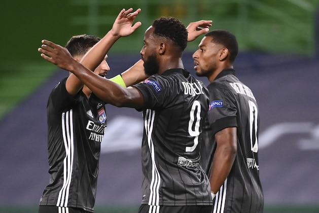 Lyon's Moussa Dembele, centre, celebrates with teammates after scoring his team's third goal during the Champions League quarterfinal match between Manchester City and Lyon at the Jose Alvalade stadium in Lisbon, Portugal, Saturday, Aug. 15, 2020. (Franck Fife/Pool Photo via AP)