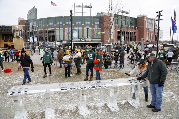 Fans tailgate before an NFL divisional playoff football game between the Green Bay Packers and the Seattle Seahawks Sunday, Jan. 12, 2020, in Green Bay, Wis. (AP Photo/Matt Ludtke)