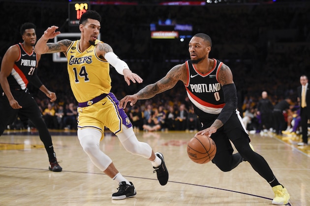 Portland Trail Blazers guard Damian Lillard, right, drives to the basket while Los Angeles Lakers guard Danny Green defends during the first half of an NBA basketball game in Los Angeles, Friday, Jan. 31, 2020. (AP Photo/Kelvin Kuo)