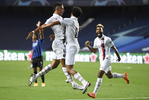 PSG's Marquinhos, centre, celebrates with teammate Thilo Kehrer, left, after scoring his team's first goal during the Champions League quarterfinal match between Atalanta and PSG at Luz stadium, Lisbon, Portugal, Wednesday, Aug. 12, 2020. (David Ramos/Pool Photo via AP)