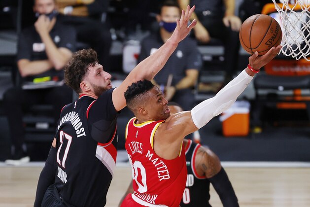 Houston Rockets' Russell Westbrook shoots the ball next to Portland Trail Blazers' Jusuf Nurkic #27 during the first half of an NBA basketball game Tuesday, Aug. 4, 2020, in Lake Buena Vista, Fla. (Kevin C. Cox/Pool Photo via AP)