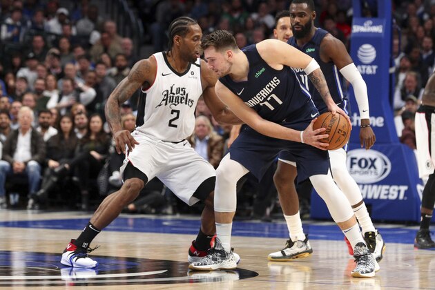 Los Angeles Clippers forward Kawhi Leonard (2) guards Dallas Mavericks forward Luka Doncic (77) during an NBA basketball game Tuesday, Jan. 21, 2020 in Dallas. (AP Photo/Richard W. Rodriguez)