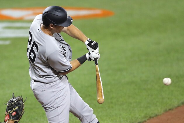 New York Yankees' DJ LeMahieu swings at a pitch from Baltimore Orioles relief pitcher Cody Carroll during the ninth inning of a baseball game, Wednesday, July 29, 2020, in Baltimore. The Yankees won 9-3. (AP Photo/Julio Cortez)