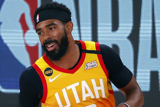 Utah Jazz' Mike Conley celebrates a three-point basket against the Denver Nuggets during the first quarter of an NBA basketball game Saturday, Aug. 8, 2020, in Lake Buena Vista, Fla. (Kevin C. Cox/Pool Photo via AP)