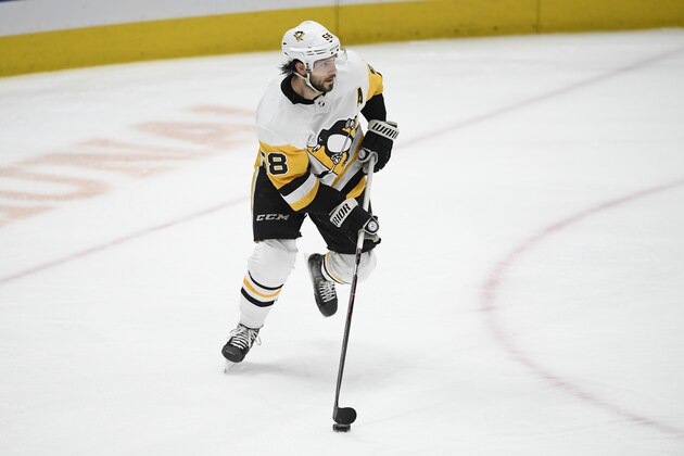 Pittsburgh Penguins defenseman Kris Letang (58) skates with the puck during the third period of an NHL hockey game against the Washington Capitals, Sunday, Feb. 23, 2020, in Washington. The Capitals won 5-3. (AP Photo/Nick Wass)