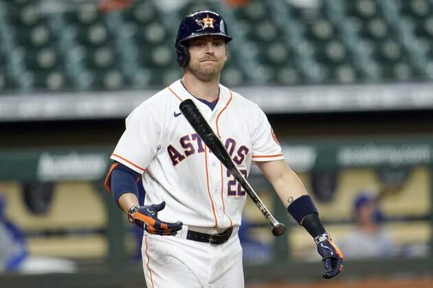 Houston Astros' Josh Reddick flips his bat after hitting a pop fly against the Los Angeles Dodgers during the fourth inning of a baseball game Wednesday, July 29, 2020, in Houston. (AP Photo/David J. Phillip)