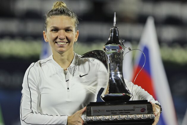 Romania's Simona Halep holds her trophy after she won Kazakhstan's Elena Rybakina in a final match of the Dubai Duty Free Tennis Championship in Dubai, United Arab Emirates, Saturday, Feb. 22, 2020. (AP Photo/Kamran Jebreili)