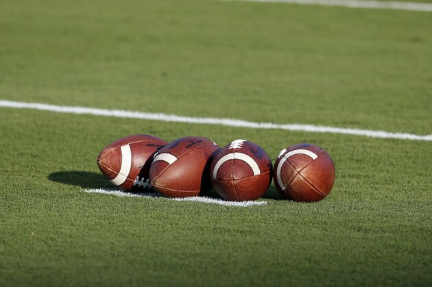 A group of footballs waits for warmups prior to an NCAA college football game between North Carolina State and the Ball State in Raleigh, N.C., Saturday, Sept. 21, 2019. (AP Photo/Karl B DeBlaker)