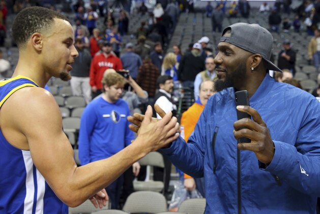 Golden State Warriors guard Stephen Curry (30) greets former Dallas Cowboys wide receiver Dez Bryant after the Warriors' 119-114 win over the Dallas Mavericks an NBA basketball game Sunday, Jan. 13, 2019, in Dallas. (AP Photo/Richard W. Rodriguez)