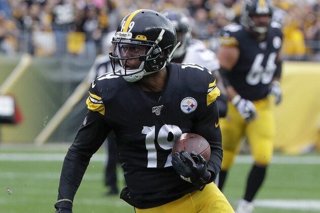 Pittsburgh Steelers wide receiver JuJu Smith-Schuster (19) tries to avoid Baltimore Ravens cornerback Marlon Humphrey (44) during an NFL football game, Sunday, Oct. 6, 2019, in Pittsburgh. (AP Photo/Don Wright)