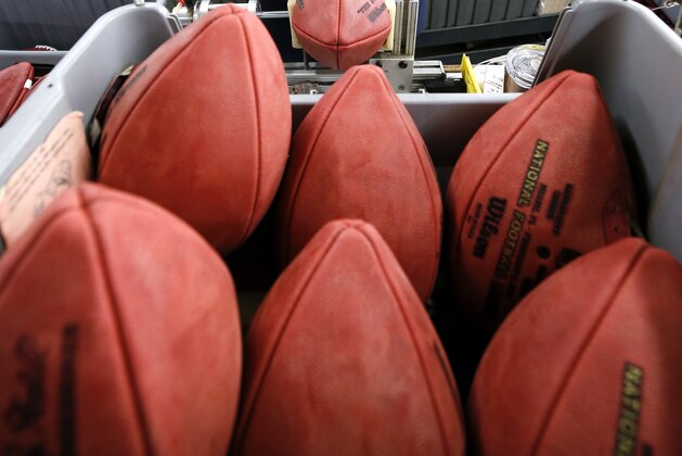 Donna Conley laces an official ball for the NFL Super Bowl LIV football game at the Wilson Sporting Goods Co. in Ada, Ohio, Monday, Jan. 20, 2020. The Kansas City Chiefs will play the San Francisco 49ers in the Super Bowl LIV on Feb. 2, in Miami. (AP Photo/Ron Schwane)