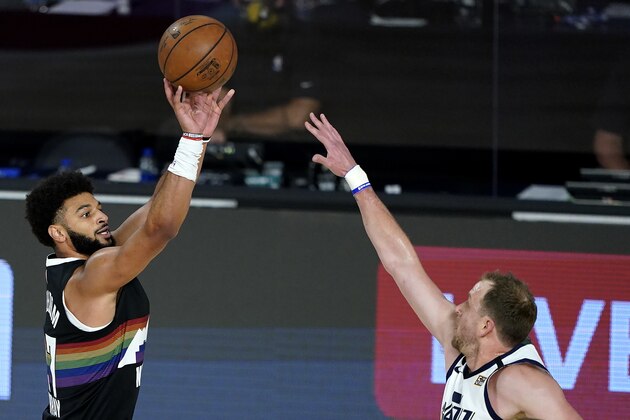 Denver Nuggets' Jamal Murray, left, shoots against Utah Jazz's Joe Ingles during the first half of an NBA basketball first round playoff game, Monday, Aug. 17, 2020, in Lake Buena Vista, Fla. (AP Photo/Ashley Landis, Pool)