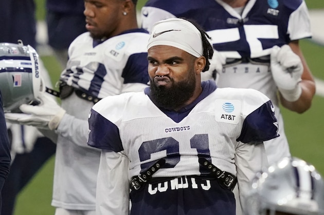 Dallas Cowboys running back Ezekiel Elliott (21) stands on the field during an NFL football training camp in Frisco, Texas, Monday, Aug. 17, 2020. (AP Photo/LM Otero)