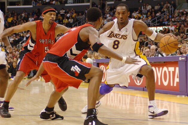Los Angeles Lakers Kobe Bryant (8) drive past Toronto Raptors' Jalen Rose, left, and Chris Both in the fourth quarter of a NBA basketball game Sunday, Jan. 22, 2006, in Los Angeles (AP Photo/Matt A. Brown)