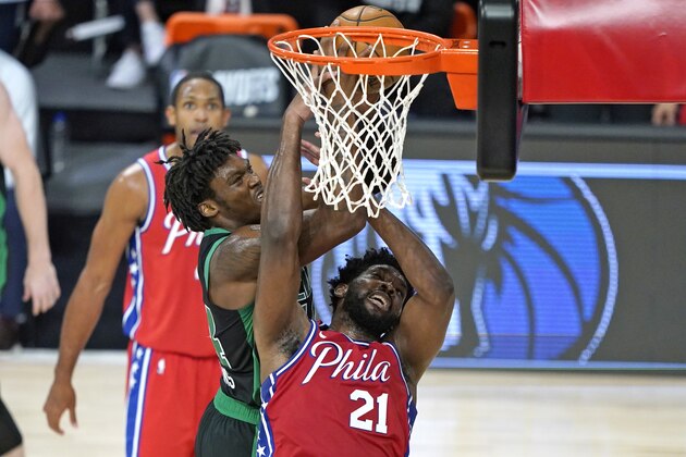 Boston Celtics' Robert Williams III, left, goes up for a shot as Philadelphia 76ers' Joel Embiid (21) defends during the first half of an NBA basketball first round playoff game Monday, Aug. 17, 2020, in Lake Buena Vista, Fla. (AP Photo/Ashley Landis, Pool)