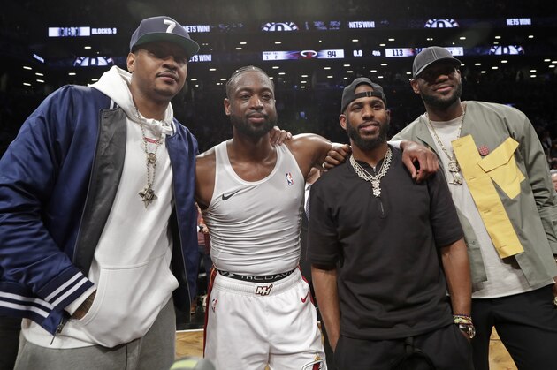 Carmelo Anthony, Miami Heat guard Dwyane Wade, Houston Rockets guard Chris Paul and Los Angeles Lakers forward LeBron James. from left, pose for a photographs on the court after Wade's final NBA basketball game, against the Brooklyn Nets on Wednesday, April 10, 2019, in New York. (AP Photo/Kathy Willens)