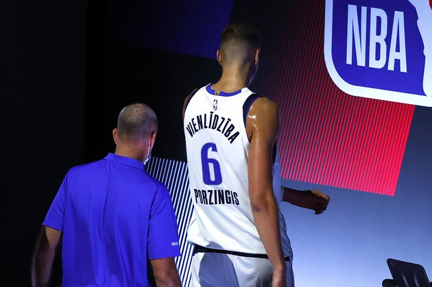 Dallas Mavericks' Kristaps Porzingis (6) leaves the court after being ejected from Game 1 of an NBA basketball first-round playoff series against the Los Angeles Clippers, Monday, Aug. 17, 2020, in Lake Buena Vista, Fla. (Kevin C. Cox/Pool Photo via AP)