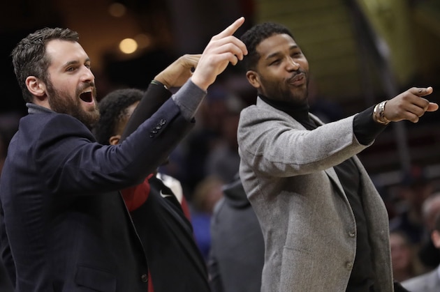 Cleveland Cavaliers' Kevin Love, left, and Tristan Thompson give support to teammates from the bench in the first half of an NBA basketball game against the Washington Wizards, Tuesday, Jan. 29, 2019, in Cleveland. The Cavaliers won 116-113. (AP Photo/Tony Dejak)