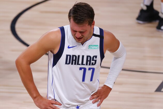 Dallas Mavericks' Luka Doncic (77) reacts after injuring himself against the Los Angeles Clippers during the first quarter of Game 1 of an NBA basketball first-round playoff series, Monday, Aug. 17, 2020, in Lake Buena Vista, Fla. (Kevin C. Cox/Pool Photo via AP)
