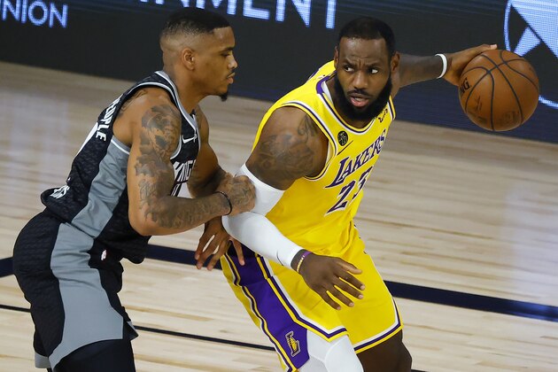 Sacramento Kings' DaQuan Jeffries, left, defends against Los Angeles Lakers' LeBron James during the second quarter of an NBA basketball game Thursday, Aug. 13, 2020, in Lake Buena Vista, Fla. (Kevin C. Cox/Pool Photo via AP)