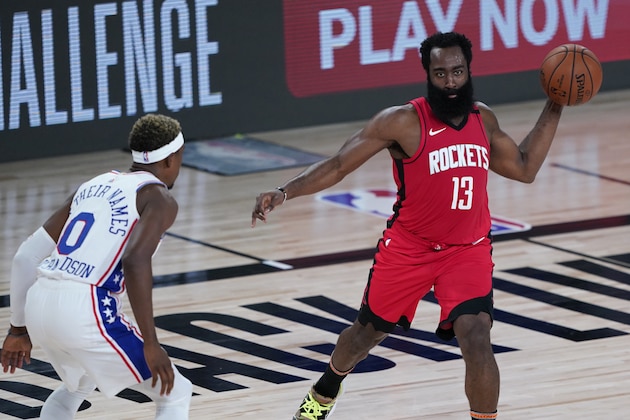 Houston Rockets' James Harden (13) passes around Philadelphia 76ers' Josh Richardson (0) during the first half of an NBA basketball game Friday, Aug. 14, 2020, in Lake Buena Vista, Fla. (AP Photo/Ashley Landis, Pool)