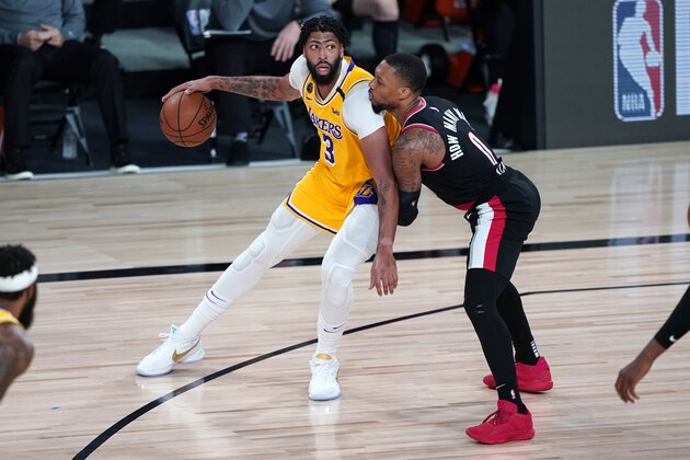 Los Angeles Lakers forward Anthony Davis (3) works the ball against Portland Trail Blazers guard Damian Lillard (0) during the second half of an NBA basketball game Tuesday, Aug. 18, 2020, in Lake Buena Vista, Fla. Portland won 100-93. (AP Photo/Ashley Landis, Pool)