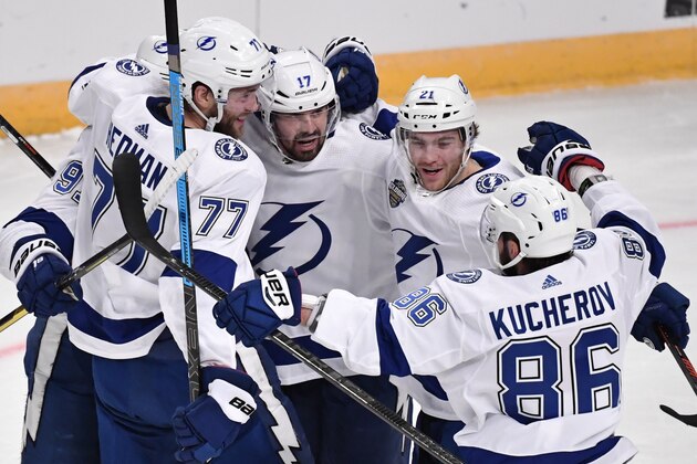 Tampa Bay Lightning's Victor Hedman (77). Alex Killorn (17) and Nikita Kucherov (86) celebrate after an NHL hockey game against the Buffalo Sabres in Globen Arena, Stockholm Sweden. Friday. Nov. 8, 2019. (Anders Wiklund/TT via AP)