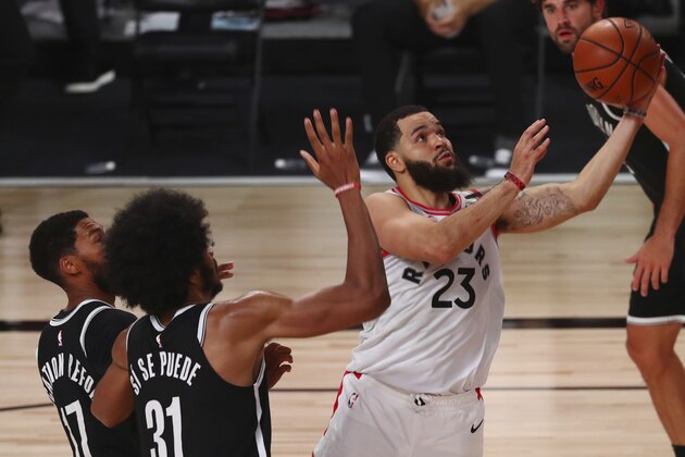 Toronto Raptors guard Fred VanVleet (23) goes up to shoot past Brooklyn Nets center Jarrett Allen (31) and guard Garrett Temple (17) during the second half of Game 1 of an NBA basketball first-round playoff series, Monday, Aug. 17, 2020, in Lake Buena Vista, Fla. (Kim Klement/Pool Photo via AP)