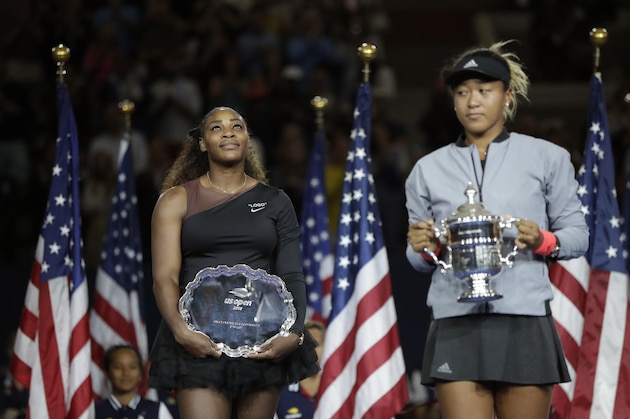 Serena Williams watches as Naomi Osaka, of Japan, holds the champions trophy in the women's final of the U.S. Open tennis tournament, Saturday, Sept. 8, 2018, in New York. (AP Photo/Julio Cortez)