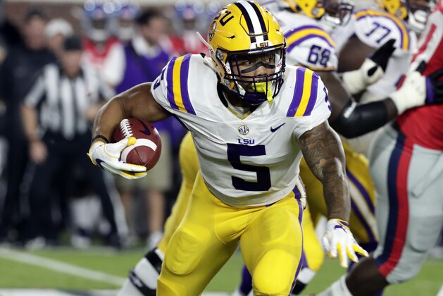 LSU running back Derrius Guice (5) runs for a first down past Mississippi defenders in the first half of an NCAA college football game in Oxford, Miss., Saturday, Oct. 21, 2017. (AP Photo/Rogelio V. Solis)